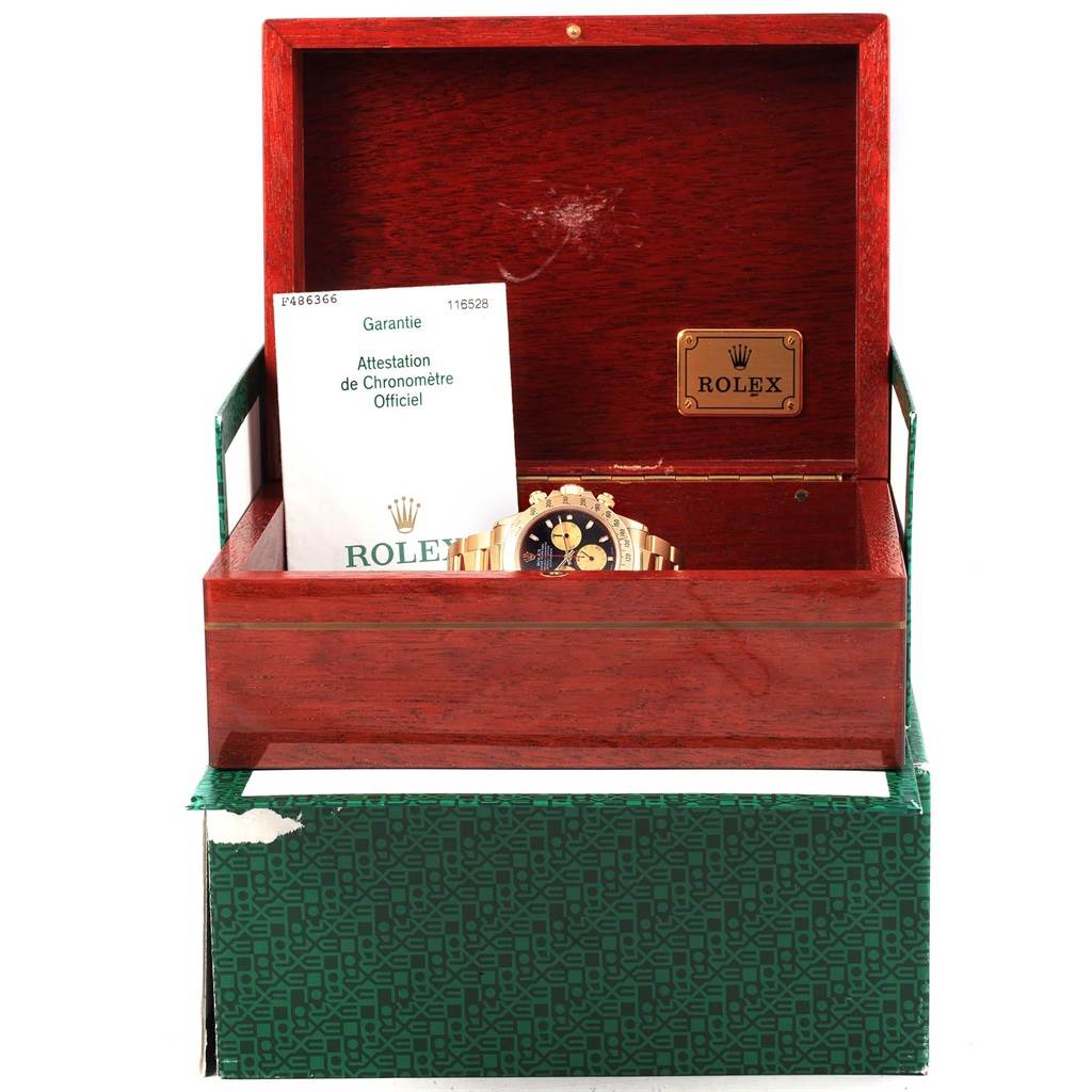 The image shows a Rolex Daytona 116528 Men's Yellow Gold Black Dial 116528 Men's Yellow Gold Black Dial watch in a wooden box with its warranty papers visible.