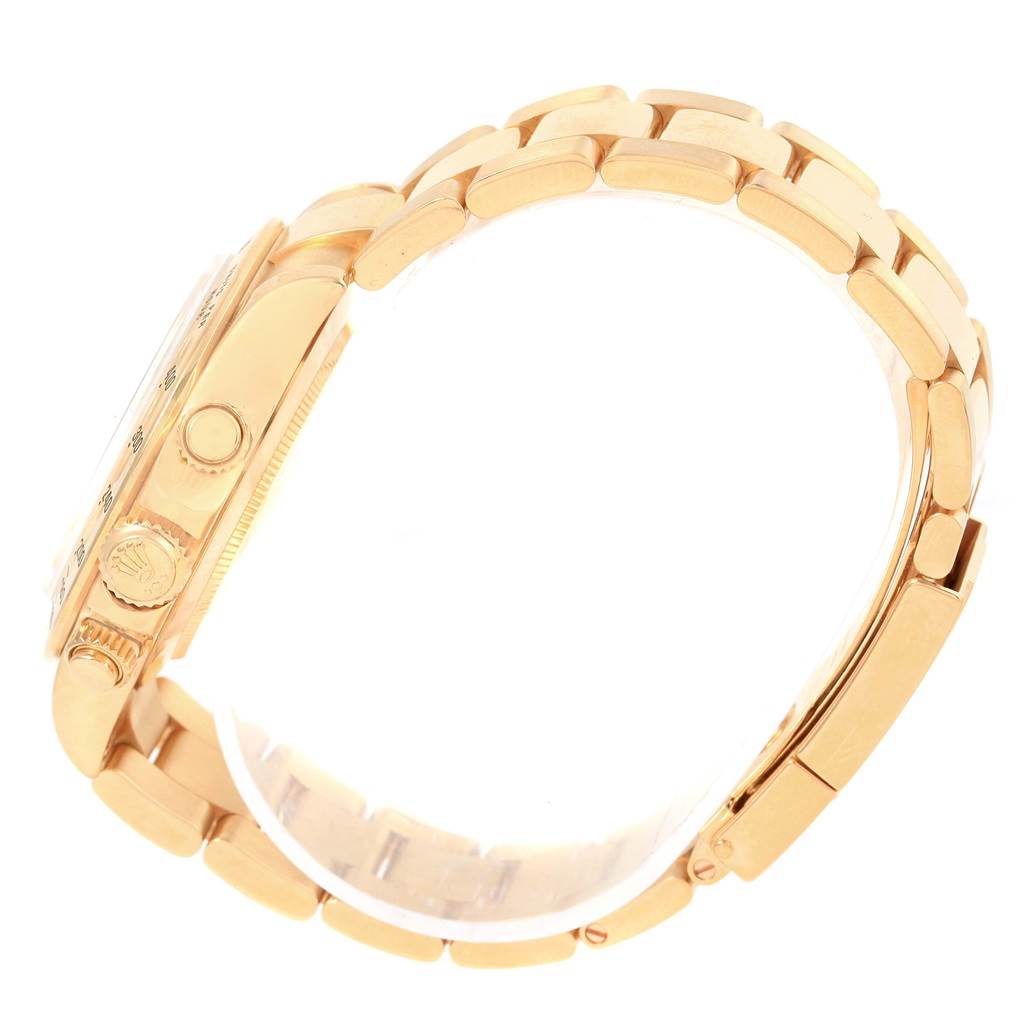 Side view of the Rolex Daytona 116528 Men's Yellow Gold White Dial 116528 Men's Yellow Gold White Dial watch showing the crown, pushers, and bracelet.