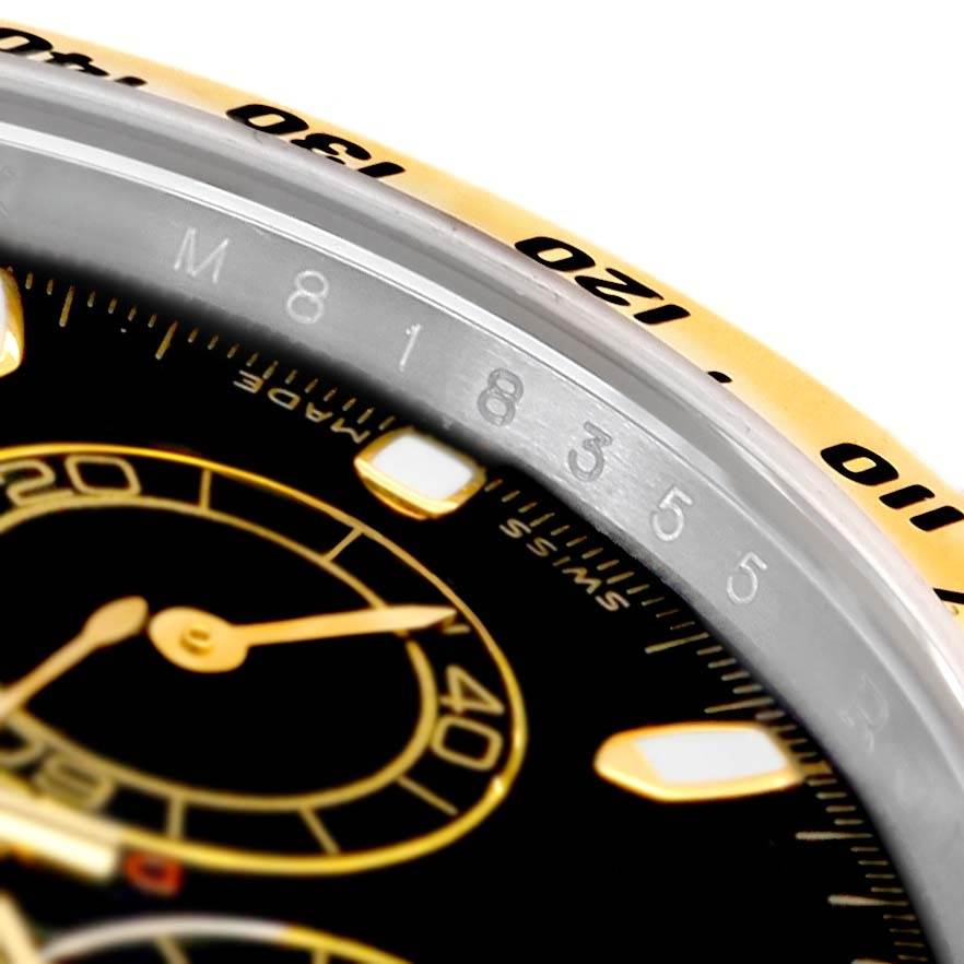 This close-up image shows the bezel and part of the dial of a Rolex Daytona 116523 Men's Steel and Gold (two tone) Black Dial 116523 Men's Steel and Gold (two tone) Black Dial watch, highlighting the tachymeter scale.