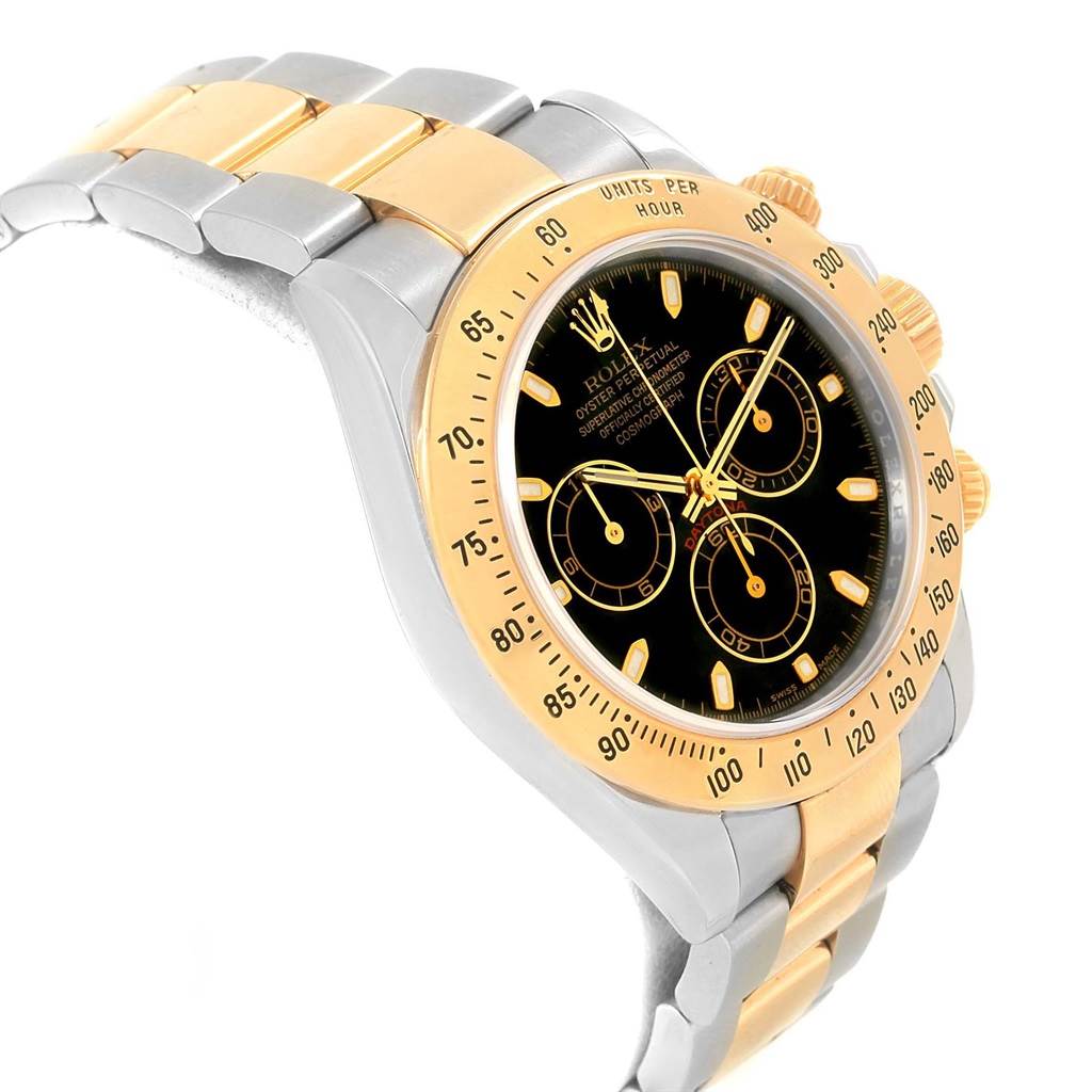 The image shows a Rolex Daytona 116523 Men's Steel and Gold (two tone) Black Dial 116523 Men's Steel and Gold (two tone) Black Dial watch at a slight angle, featuring its black dial, gold bezel, and silver and gold bracelet.