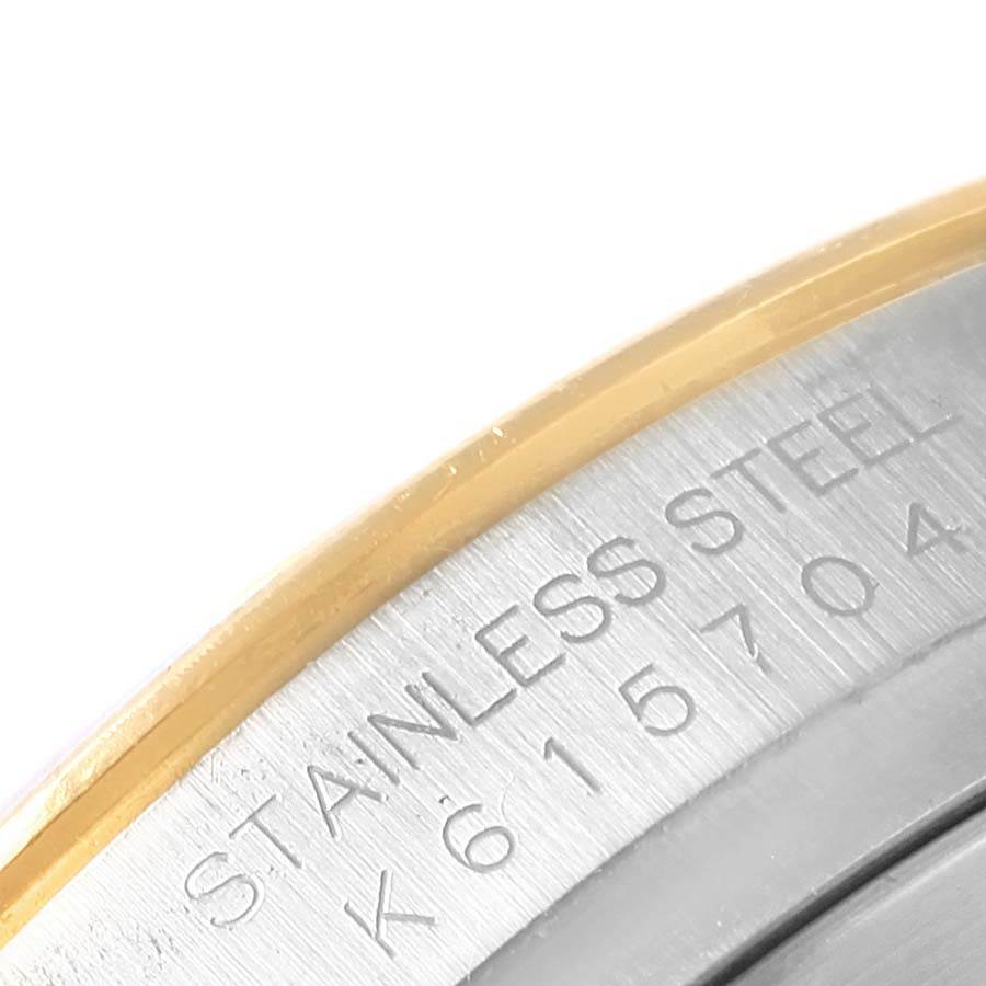 This close-up image shows the edge and part of the casing with engravings of a Rolex Daytona 116523 Men's Steel and Gold (two tone) Mother of Pearl Dial 116523 Men's Steel and Gold (two tone) Mother of Pearl Dial watch.