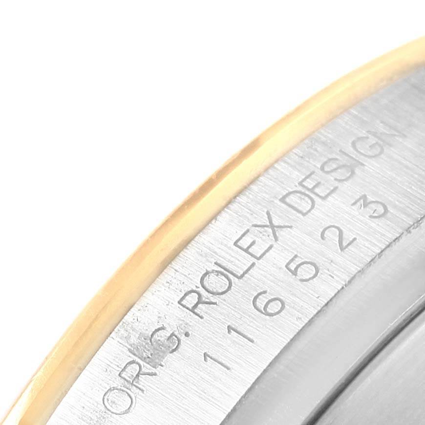 The image shows a close-up of the side engraving on a Rolex Daytona 116523 Men's Steel and Gold (two tone) Mother of Pearl Dial 116523 Men's Steel and Gold (two tone) Mother of Pearl Dial watch, detailing part of the model number and design inscription.