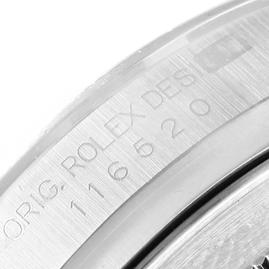 This image shows a close-up of the engraved side of the bezel of a Rolex Daytona 116520 Men's Stainless Steel Black Dial 116520 Men's Stainless Steel Black Dial watch.