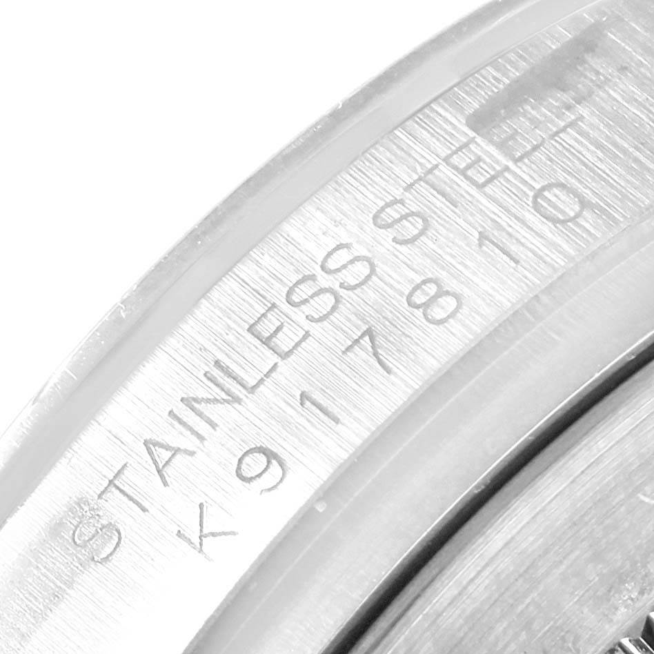 This close-up image shows the engraved serial number on the casing of a Rolex Daytona 116520 Men's Stainless Steel Black Dial 116520 Men's Stainless Steel Black Dial watch.
