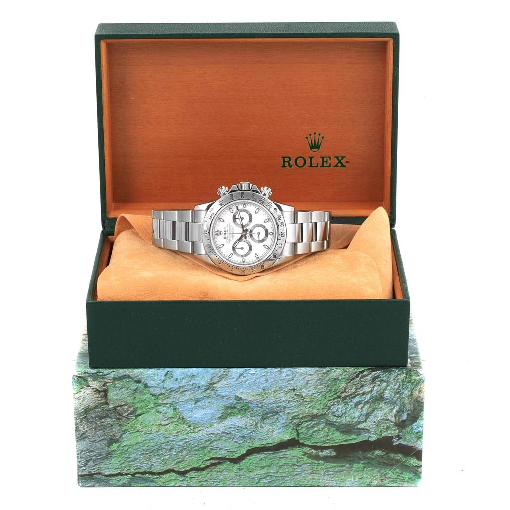 The Rolex Daytona 116520 Men's Stainless Steel White Dial 116520 Men's Stainless Steel White Dial watch is shown front-facing in its open, branded box with the bracelet displayed.