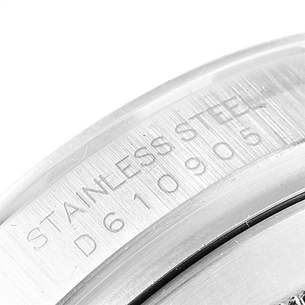 This close-up image shows the engraved serial number and 'STAINLESS STEEL' text on the side of the Rolex Daytona 116520 Men's Stainless Steel White Dial 116520 Men's Stainless Steel White Dial model watch.