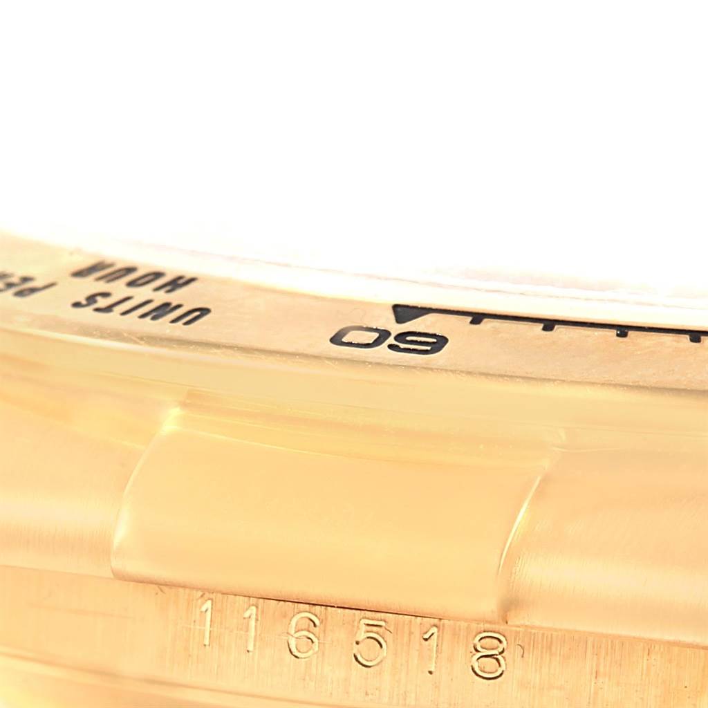 A close-up of the bezel and case of a Rolex Daytona 116518 Men's Stainless Steel Mother of Pearl Dial 116518 Men's Stainless Steel Mother of Pearl Dial watch, showing part of the tachymeter scale and the reference number 116518.