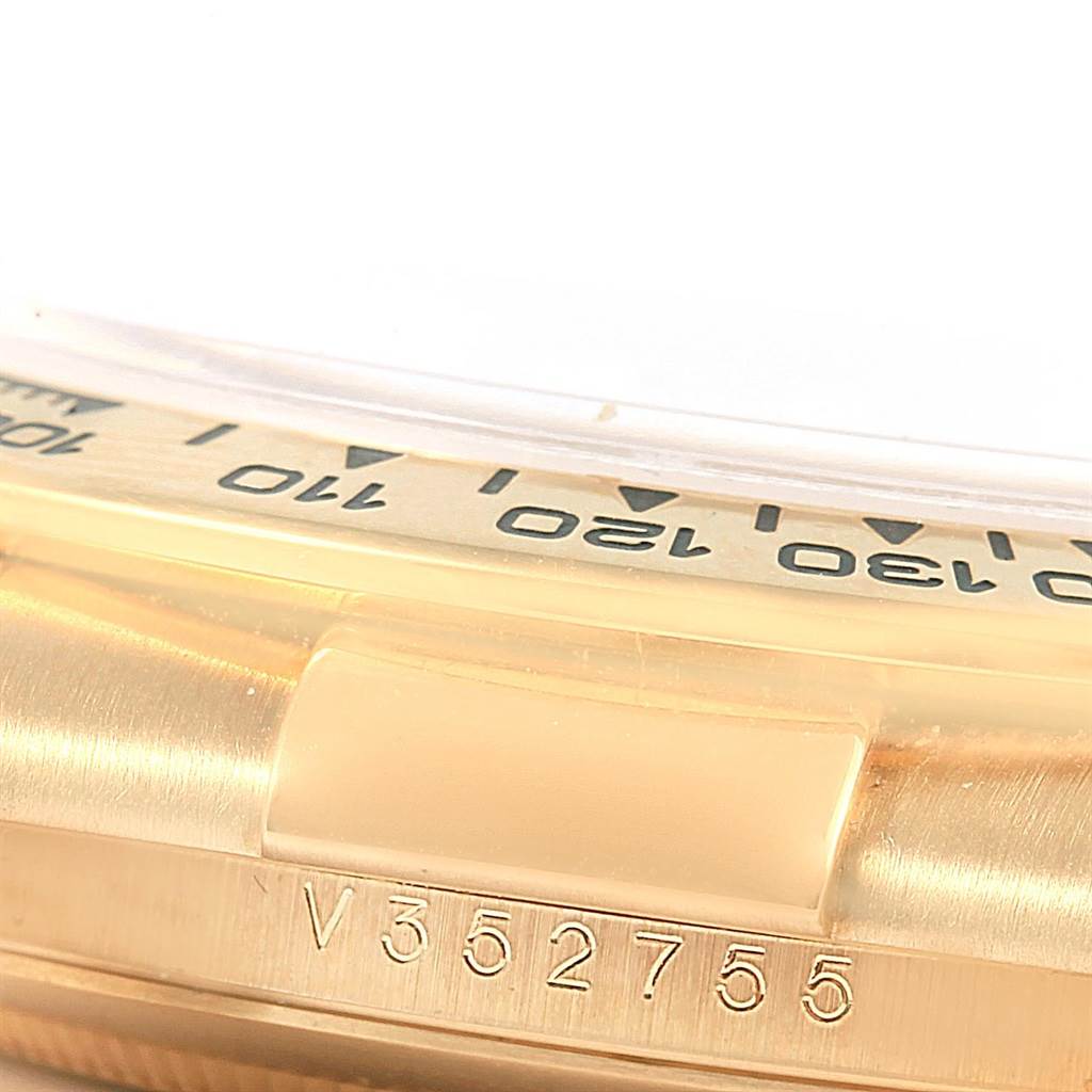 This image shows a close-up of the side of a Rolex Daytona 116518 Men's Stainless Steel Mother of Pearl Dial 116518 Men's Stainless Steel Mother of Pearl Dial watch, focusing on its bezel and serial number.