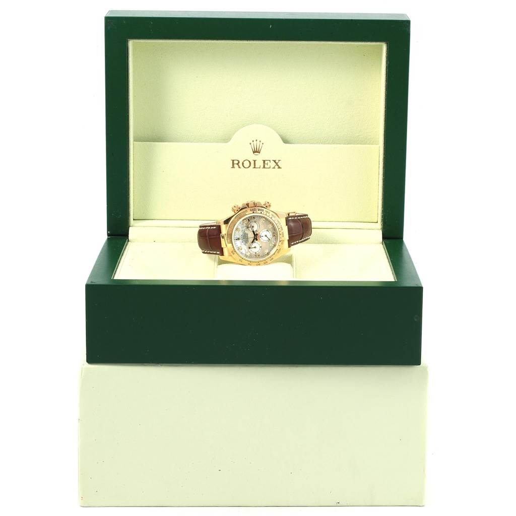 This image shows a Rolex Daytona 116518 Men's Stainless Steel Mother of Pearl Dial 116518 Men's Stainless Steel Mother of Pearl Dial watch with a brown leather strap displayed in its open green and beige box.