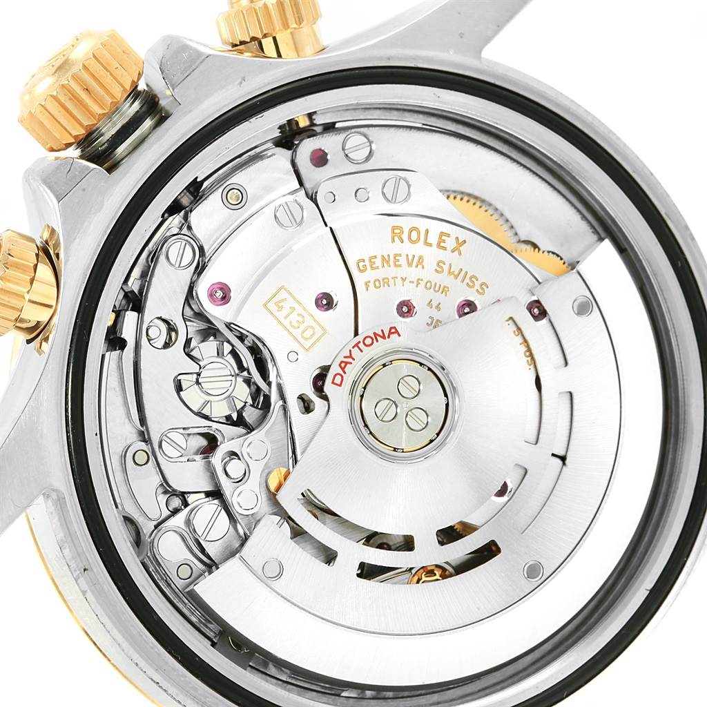 The image shows a close-up view of the back side of the Rolex Daytona 116523 Men's Stainless Steel Grey Dial 116523 Men's Stainless Steel Grey Dial watch, showcasing its internal movement and mechanisms.