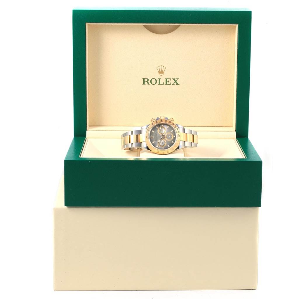 The image shows a front view of the Rolex Daytona 116523 Men's Stainless Steel Grey Dial 116523 Men's Stainless Steel Grey Dial watch placed in its open green and beige Rolex box.
