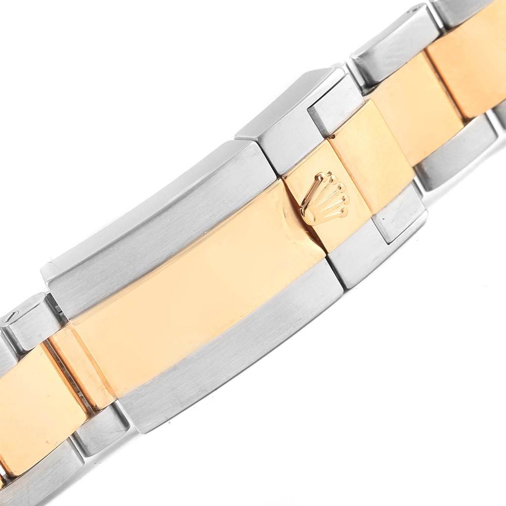 The image shows the clasp and part of the bracelet of a Rolex Daytona 116523 Men's Stainless Steel Grey Dial 116523 Men's Stainless Steel Grey Dial watch, featuring a two-tone metal design.