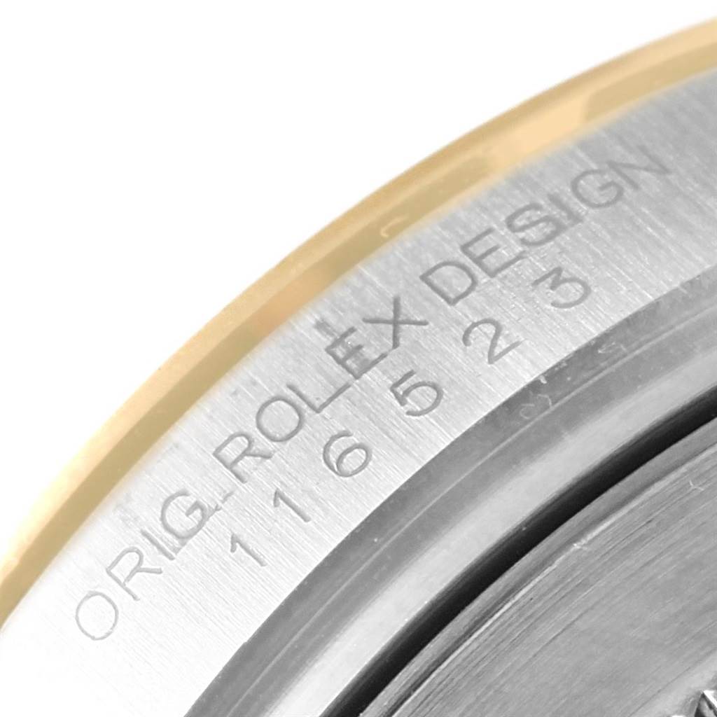 This image shows the edge of the casing with engraved markings of a Rolex Daytona 116523 Men's Steel and Gold (two tone) Champagne Dial 116523 Men's Steel and Gold (two tone) Champagne Dial watch.