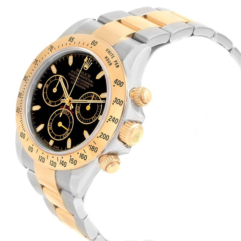 The Rolex Daytona 116523 Men's Steel and Gold (two tone) Black Dial 116523 Men's Steel and Gold (two tone) Black Dial watch is shown at an angle highlighting its black dial, gold bezel, pushers, crown, and two-tone bracelet.