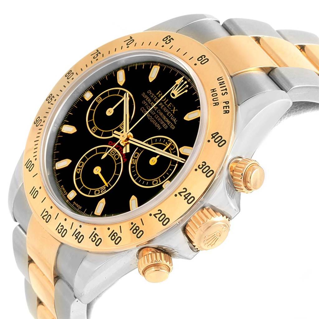 The image shows a close-up angled view of a Rolex Daytona 116523 Men's Steel and Gold (two tone) Black Dial 116523 Men's Steel and Gold (two tone) Black Dial watch, highlighting the face, crown, and part of the bracelet.