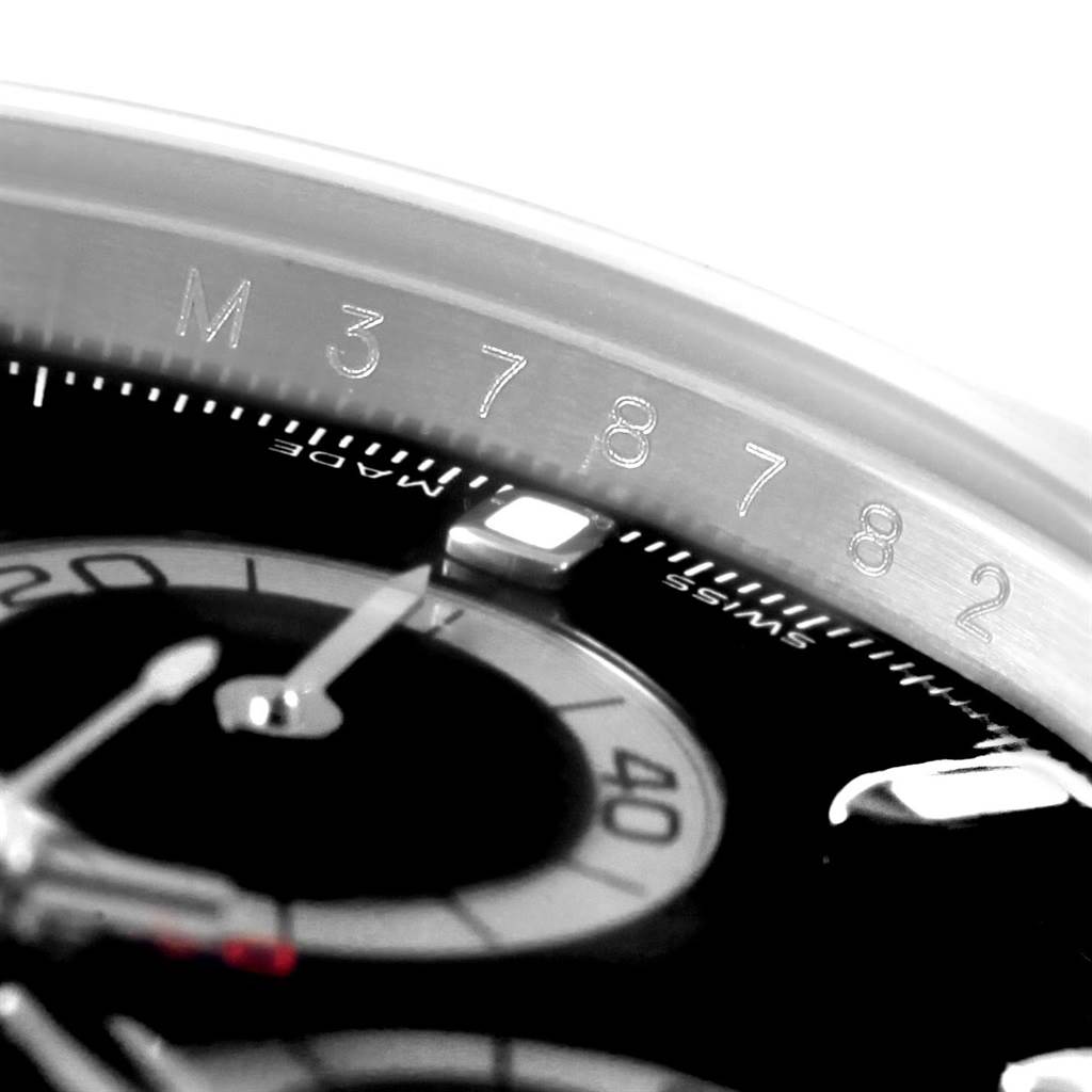 The image shows a close-up of the Rolex Daytona 116520 Men's Stainless Steel Black Dial 116520 Men's Stainless Steel Black Dial watch face, highlighting the hour markers and part of the bezel with engraved numbers.