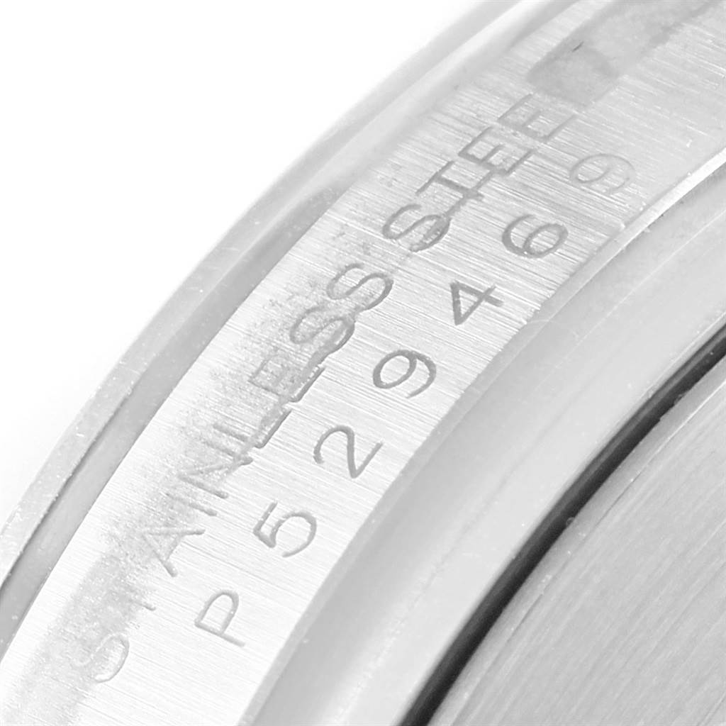 This image shows a close-up of the outer casing of a Rolex Daytona 116520 Men's Stainless Steel Black Dial 116520 Men's Stainless Steel Black Dial watch, highlighting the "STAINLESS STEEL P 529469" engraving.