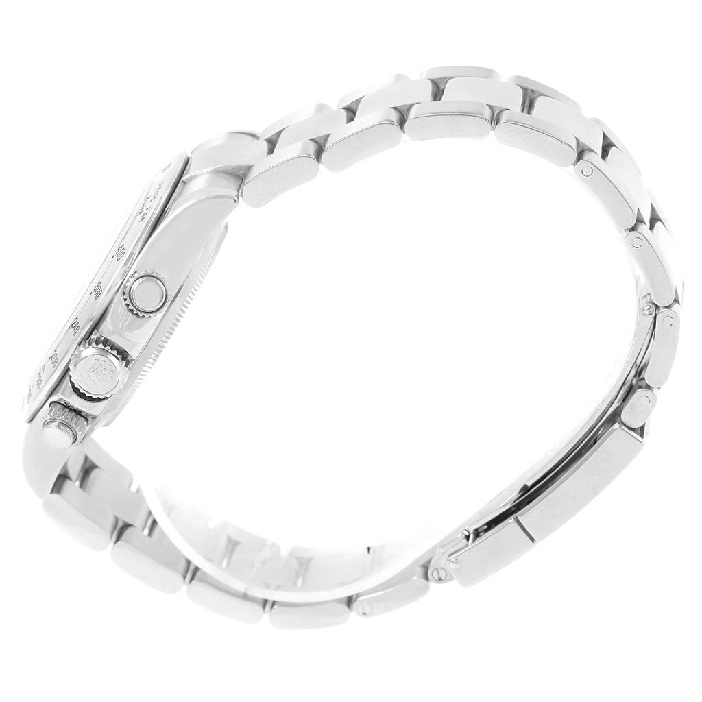 The image shows a side profile of a Rolex Daytona 116520 Men's Stainless Steel Black Dial 116520 Men's Stainless Steel Black Dial watch, highlighting its crown, pushers, and metallic bracelet.