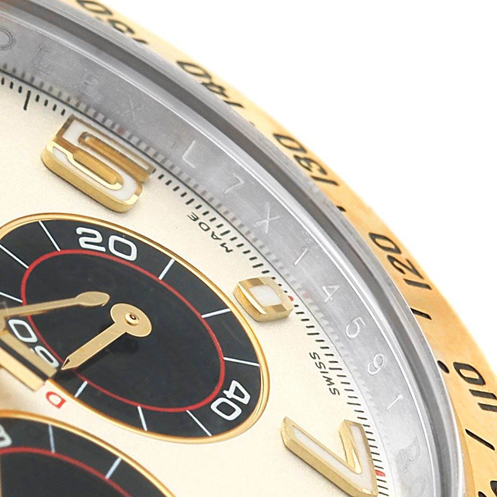 This image shows a close-up angle of the dial and bezel of a Rolex Daytona 116523 Men's Steel and Gold (two tone) White Dial 116523 Men's Steel and Gold (two tone) White Dial watch.