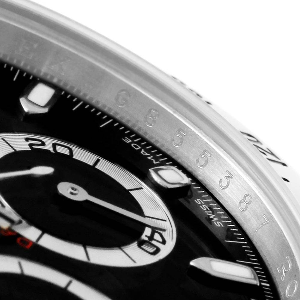 The image shows a close-up of the Rolex Daytona 116520 Men's Stainless Steel Black Dial 116520 Men's Stainless Steel Black Dial watch, focusing on its bezel, sub-dials, and part of the hour markers.