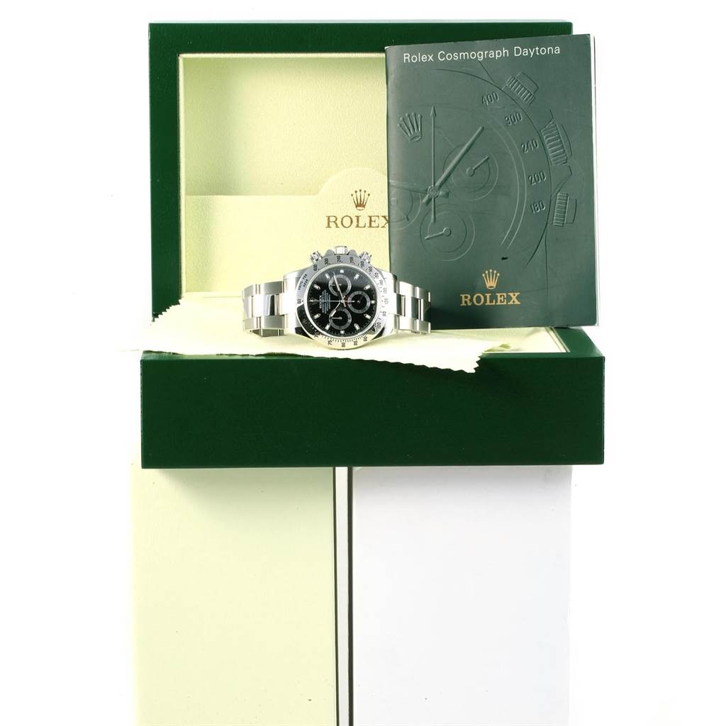 The image shows a Rolex Daytona 116520 Men's Stainless Steel Black Dial 116520 Men's Stainless Steel Black Dial watch placed in its open green box with the booklet to the right.
