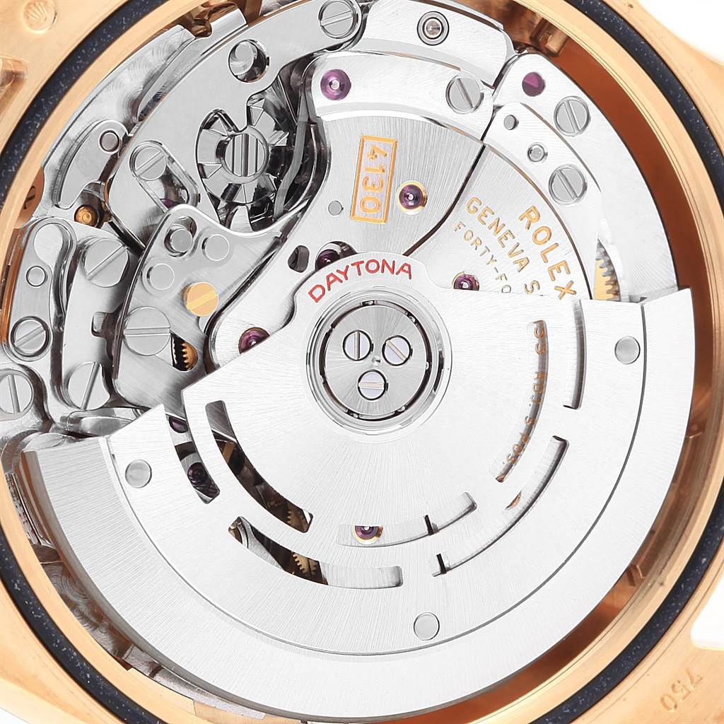 The image shows the internal mechanism of the Rolex Daytona 116528 Men's Yellow Gold White Dial 116528 Men's Yellow Gold White Dial watch, focusing on the movement and rotor components.