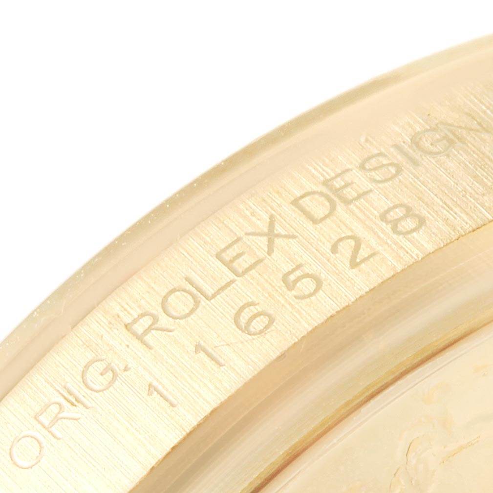 This image shows a close-up of the case back rim of a Rolex Daytona 116528 Men's Yellow Gold White Dial 116528 Men's Yellow Gold White Dial watch, highlighting the engraved design details.