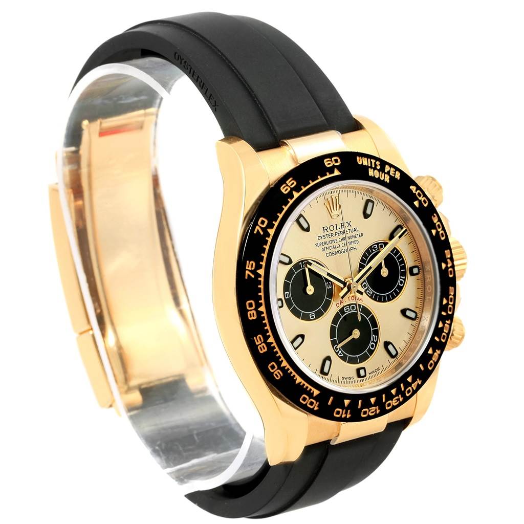 This image shows a Rolex Daytona 116518 Men's Yellow Gold Champagne Dial 116518 Men's Yellow Gold Champagne Dial watch from an angle displaying the face, bezel, side buttons, and black Oysterflex strap.