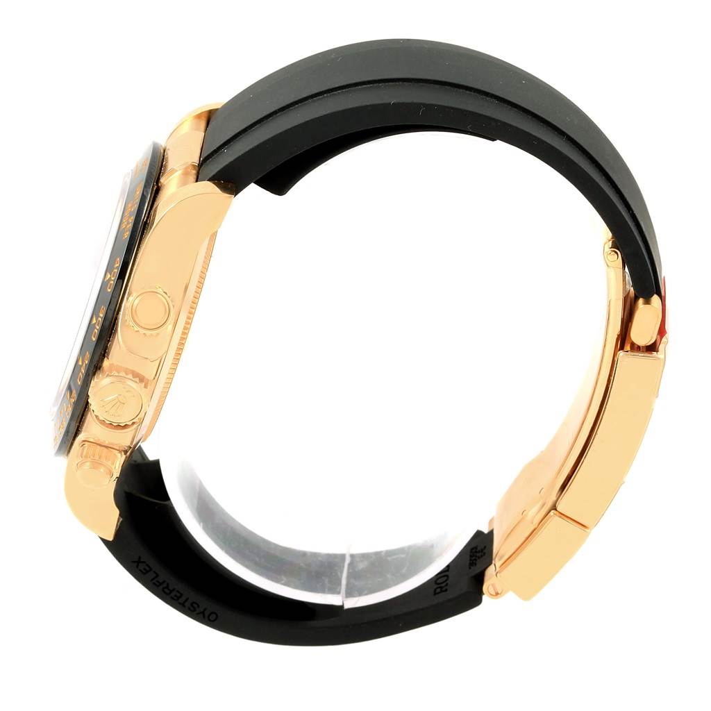 This Rolex Daytona 116518 Men's Yellow Gold Champagne Dial 116518 Men's Yellow Gold Champagne Dial watch is shown from a side angle, displaying the case, crown, pushers, and part of the black strap.