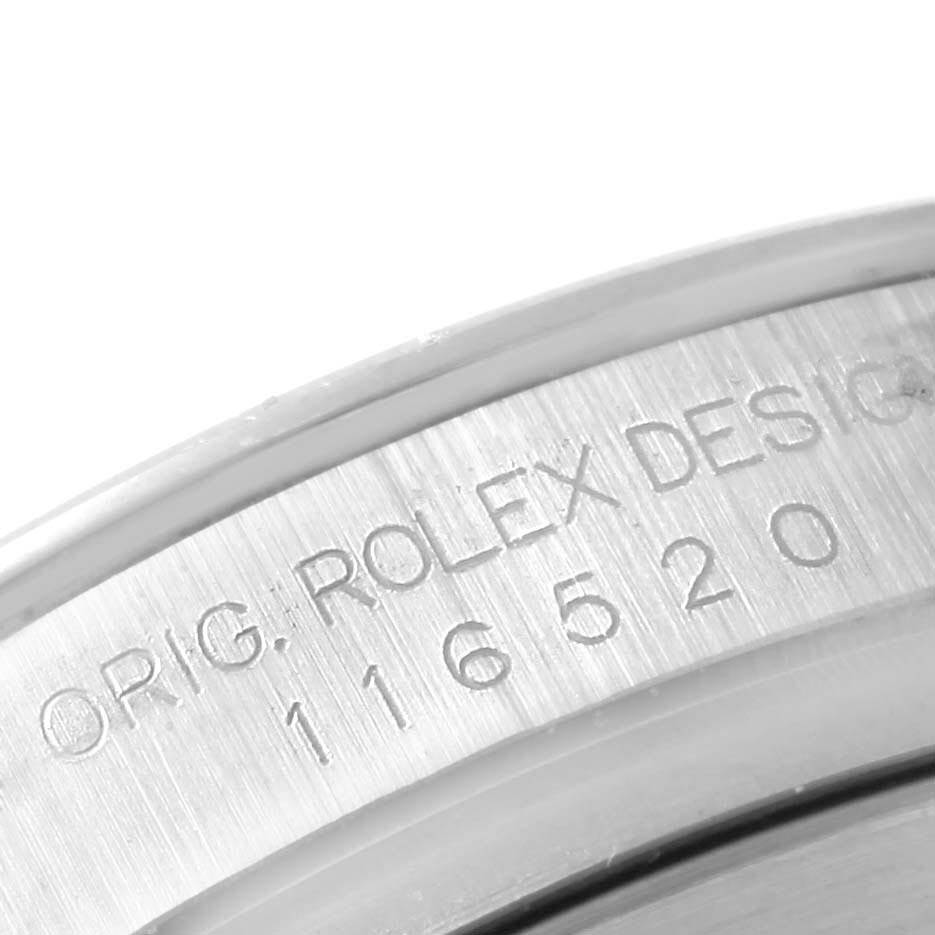 The image shows an engraved serial and model number on the side of the case of a Rolex Daytona 116520 Men's Stainless Steel White Dial 116520 Men's Stainless Steel White Dial watch.