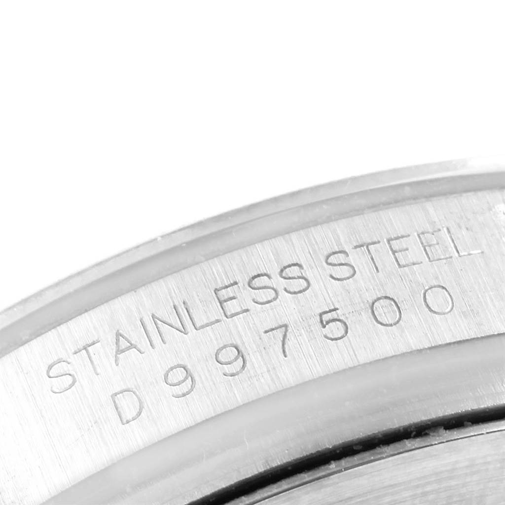 The image shows a close-up of the serial number and "STAINLESS STEEL" engraving on a Rolex Daytona 116520 Men's Stainless Steel Black Dial 116520 Men's Stainless Steel Black Dial watch case.