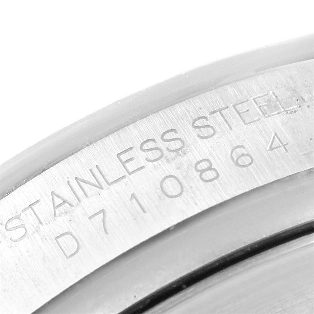 This image shows a close-up of the engraved serial number and "STAINLESS STEEL" text on the case back of a Rolex Daytona 116520 Men's Stainless Steel White Dial 116520 Men's Stainless Steel White Dial watch.