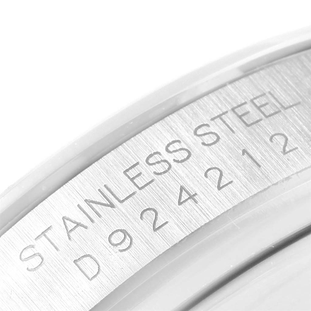 This image shows the side angle of the Rolex Daytona 116520 Men's Stainless Steel White Dial 116520 Men's Stainless Steel White Dial watch, highlighting its stainless steel casing and serial number.