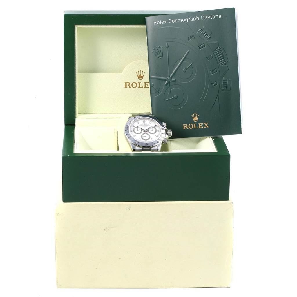 The image shows a front view of a Rolex Daytona 116520 Men's Stainless Steel White Dial 116520 Men's Stainless Steel White Dial watch in a green box with its instruction manual.