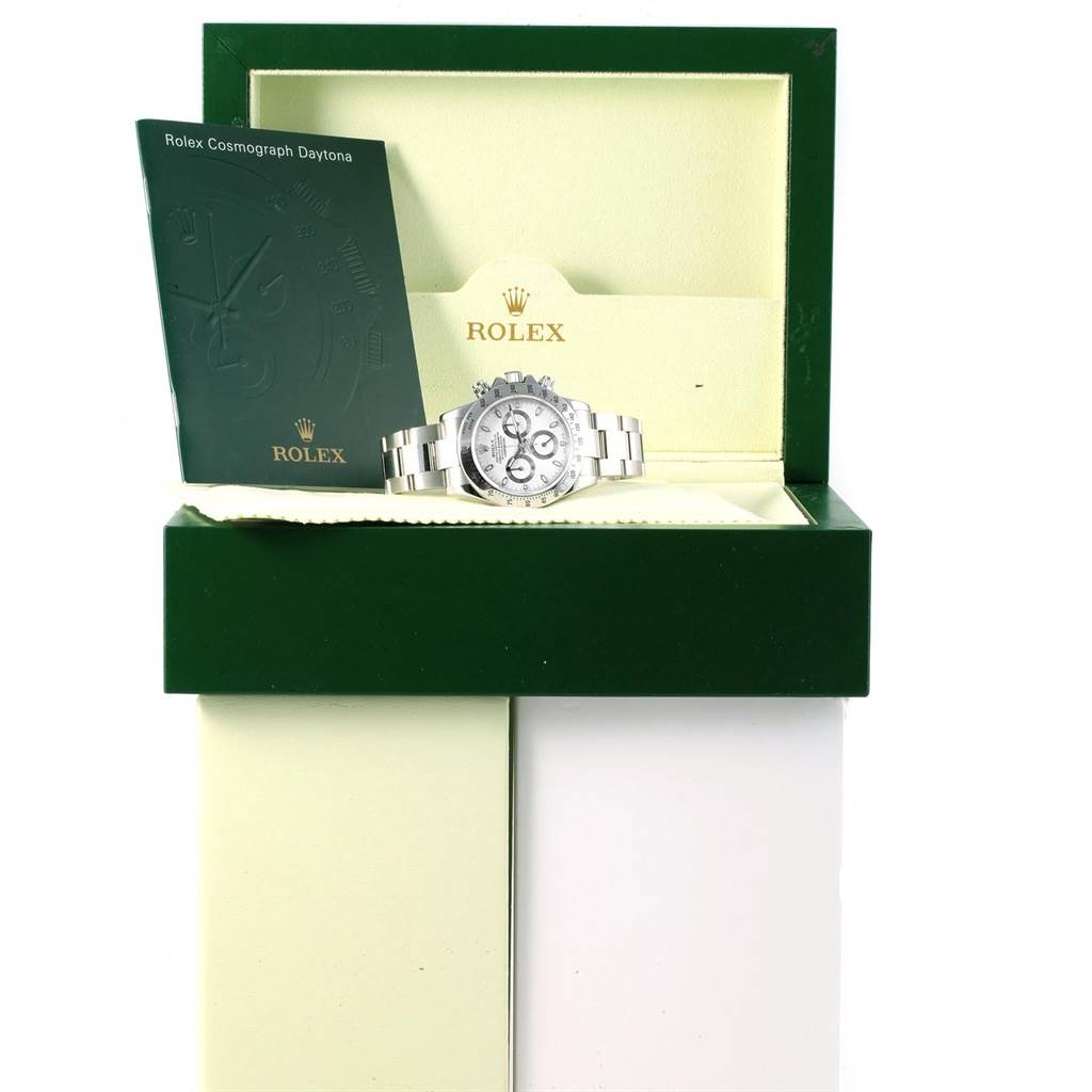 The image shows a Rolex Daytona 116520 Men's Stainless Steel White Dial 116520 Men's Stainless Steel White Dial watch from a front angle, inside its open box accompanied by the instruction manual.