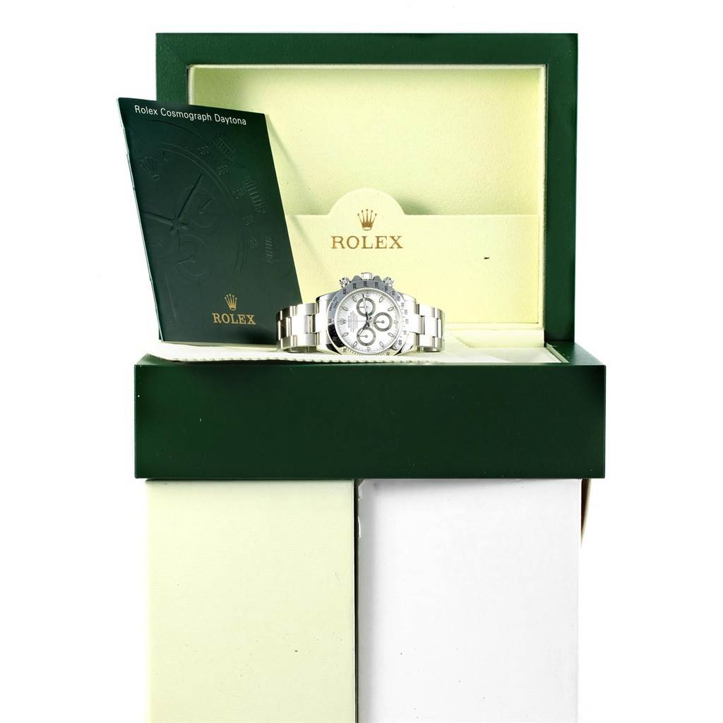 The image shows a Rolex Daytona 116520 Men's Stainless Steel White Dial 116520 Men's Stainless Steel White Dial watch positioned in its open box with a Rolex booklet to the left side.