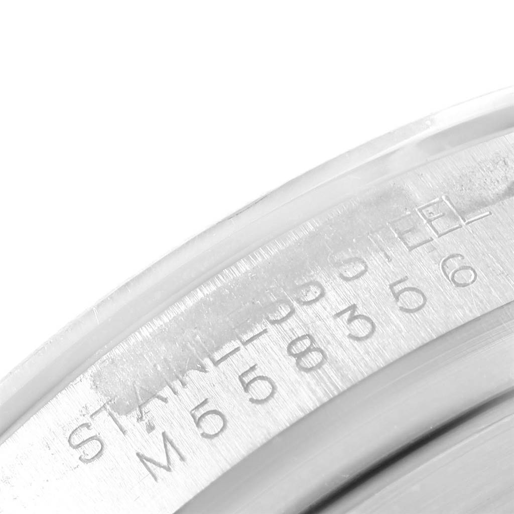 This image shows a close-up of a portion of the case back of a Rolex Daytona 116520 Men's Stainless Steel White Dial 116520 Men's Stainless Steel White Dial, focusing on the engraved model and serial number.