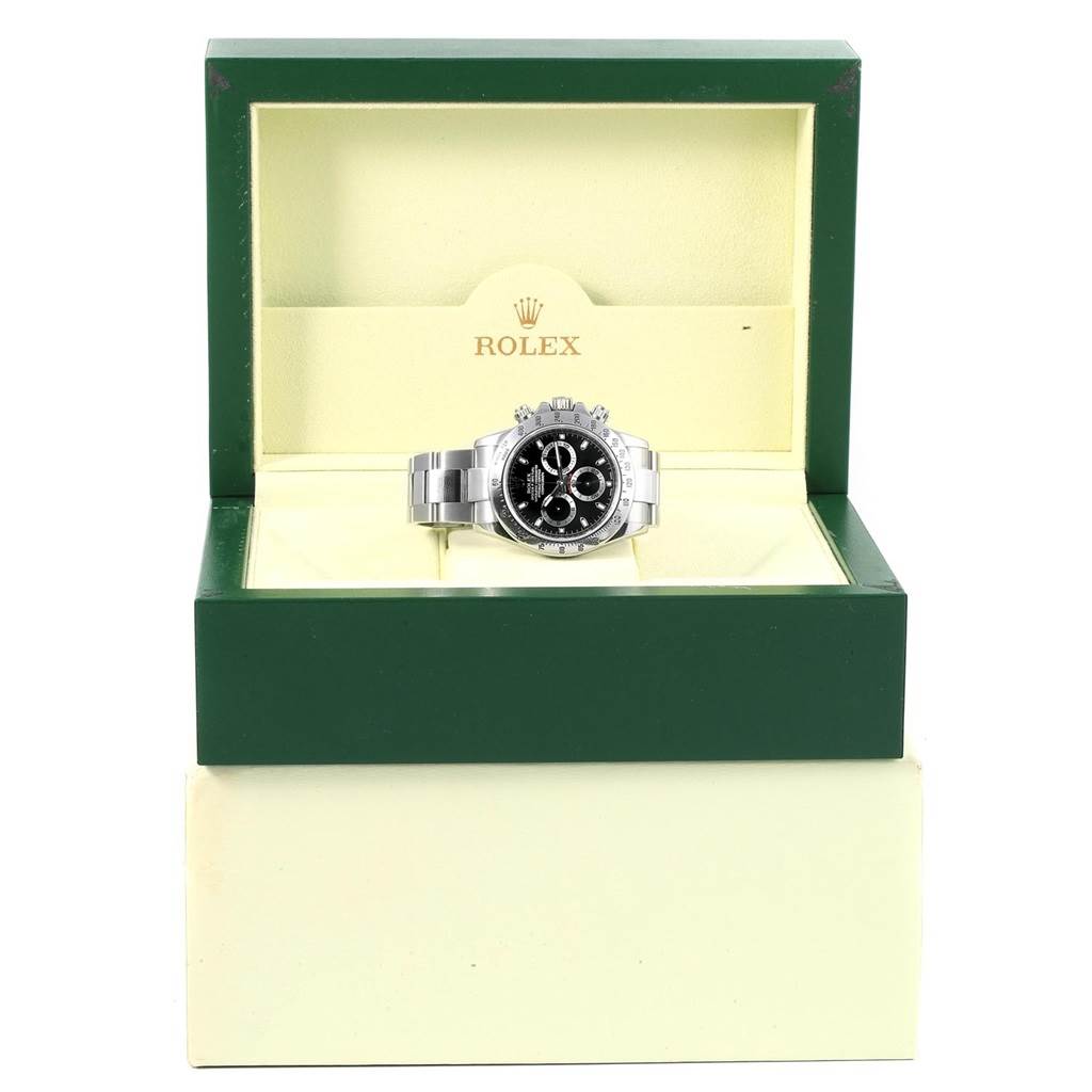 The image shows a Rolex Daytona 116520 Men's Stainless Steel Black Dial 116520 Men's Stainless Steel Black Dial watch viewed from the front, displayed in an open, green watch box.