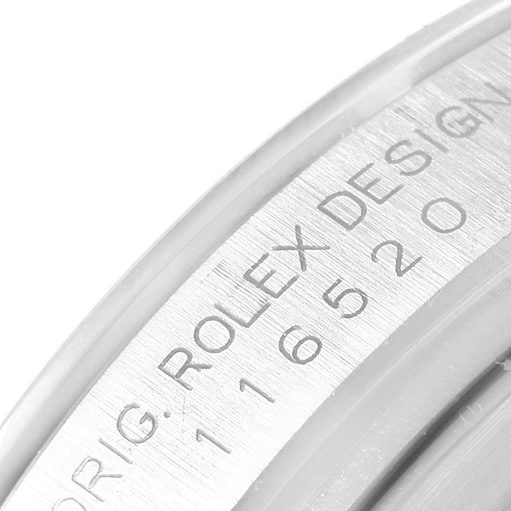 This image shows a close-up of the engraved bezel on a Rolex Daytona 116520 Men
s Stainless Steel White Dial 116520 Men
s Stainless Steel White Dial watch.