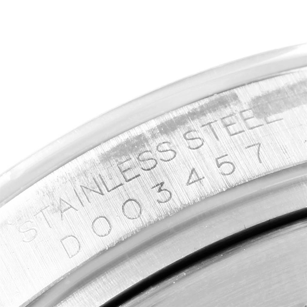 This image shows a close-up view of the stainless steel casing back and serial number engraving of a Rolex Daytona 116520 Men
s Stainless Steel White Dial 116520 Men
s Stainless Steel White Dial watch.