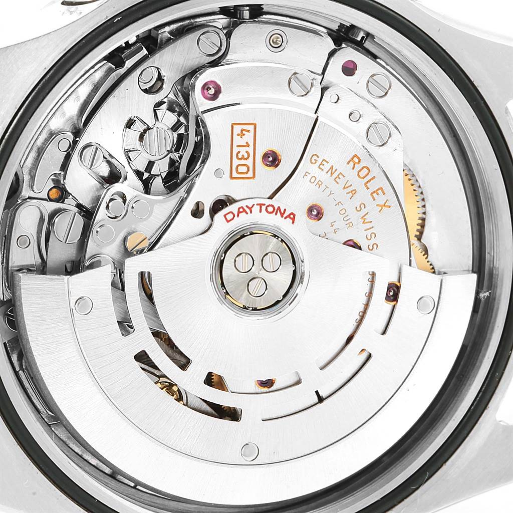 The image shows the detailed inner mechanism of a Rolex Daytona 116520 Men
s Stainless Steel White Dial 116520 Men
s Stainless Steel White Dial watch, focusing on its movement components and engravings.