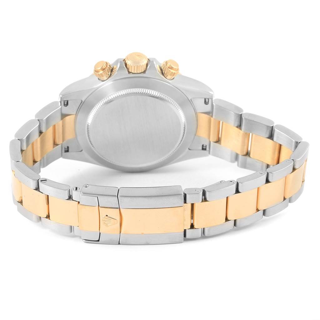 The image shows the back case, crown, and bracelet of a Rolex Daytona 116523 Men's Steel and Gold (two tone) Black Dial 116523 Men's Steel and Gold (two tone) Black Dial watch, featuring a two-tone metal design.