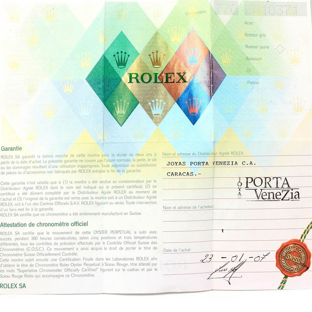 This image shows the warranty card and certificate for a Rolex Daytona 116523 Men's Steel and Gold (two tone) Black Dial 116523 Men's Steel and Gold (two tone) Black Dial watch, featuring the brand logo and distributor details.