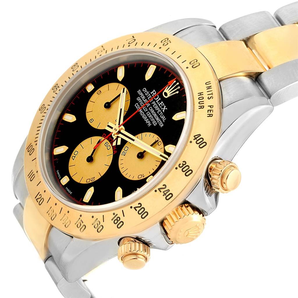 The image shows a close-up side angle of a Rolex Daytona 116523 Men's Steel and Gold (two tone) Black Dial 116523 Men's Steel and Gold (two tone) Black Dial watch, highlighting its bezel, crown, pushers, and part of the bracelet.