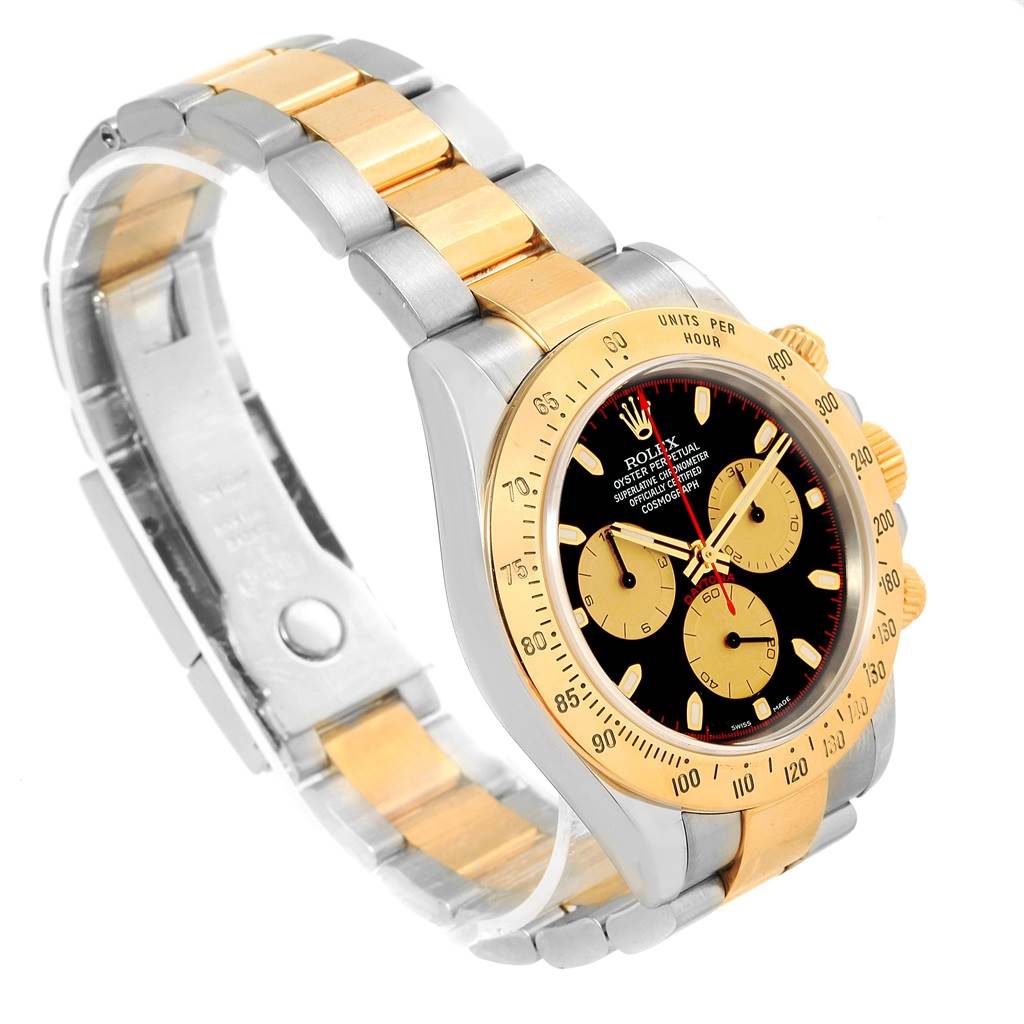 This image shows a Rolex Daytona 116523 Men's Steel and Gold (two tone) Black Dial 116523 Men's Steel and Gold (two tone) Black Dial watch at a three-quarter angle, highlighting its bezel, dial, and two-tone bracelet.