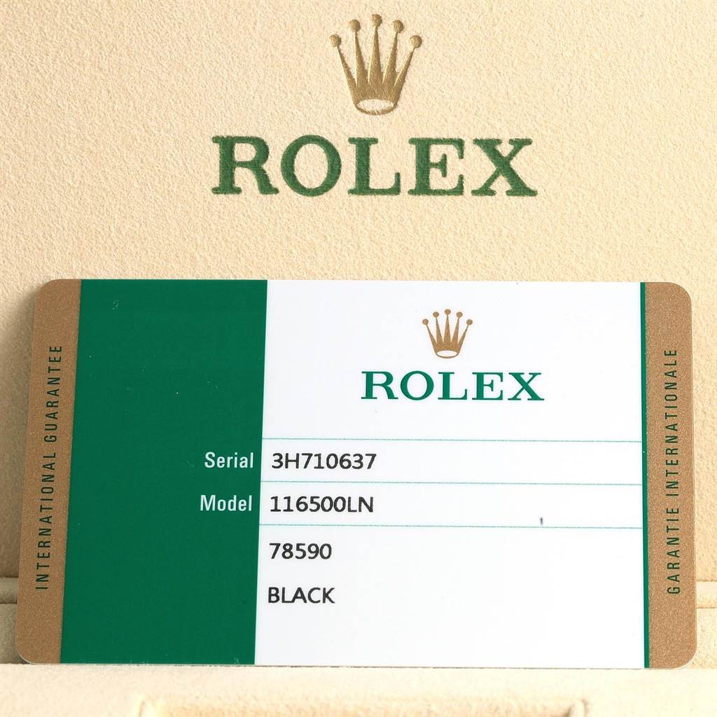 The image shows a close-up of the warranty card for the Rolex Daytona 116500 Men's Stainless Steel Black Dial 116500 Men's Stainless Steel Black Dial model 116500LN, featuring serial number, and model details.