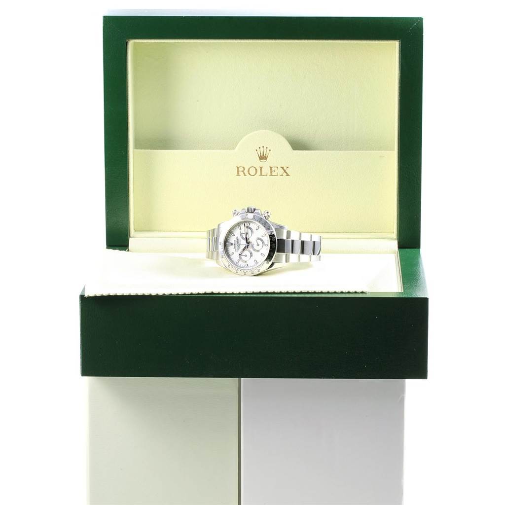 The image shows a Rolex Daytona 116520 Men's Stainless Steel White Dial 116520 Men's Stainless Steel White Dial watch displayed inside its open green and cream-colored box, viewed from the front.