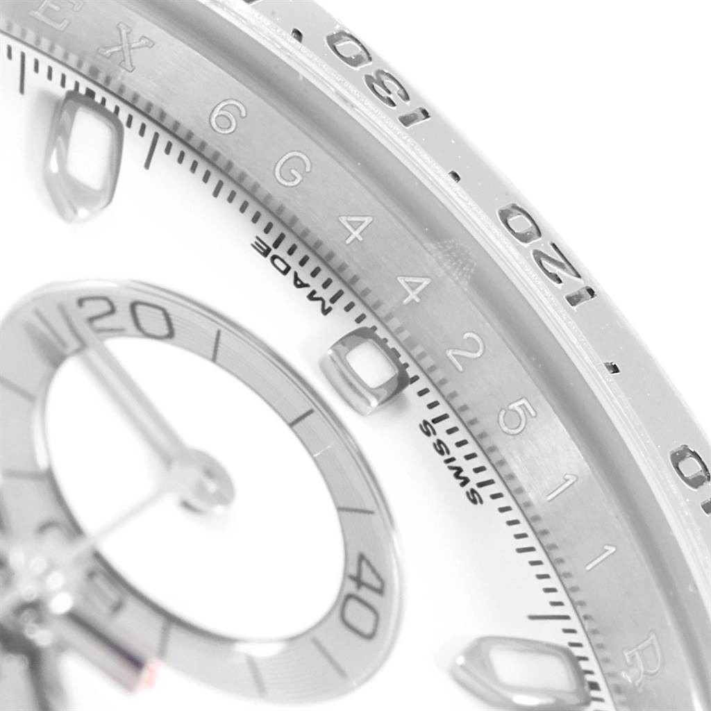 Close-up of a Rolex Daytona 116520 Men's Stainless Steel White Dial 116520 Men's Stainless Steel White Dial showing part of the bezel with engraved numerals and a detailed view of the sub-dial.