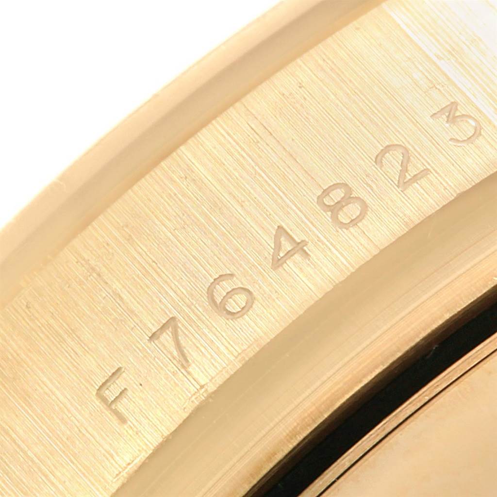 The image shows a close-up view of the serial number on a Rolex Daytona 116528 Men's Yellow Gold Champagne Dial 116528 Men's Yellow Gold Champagne Dial watch case.