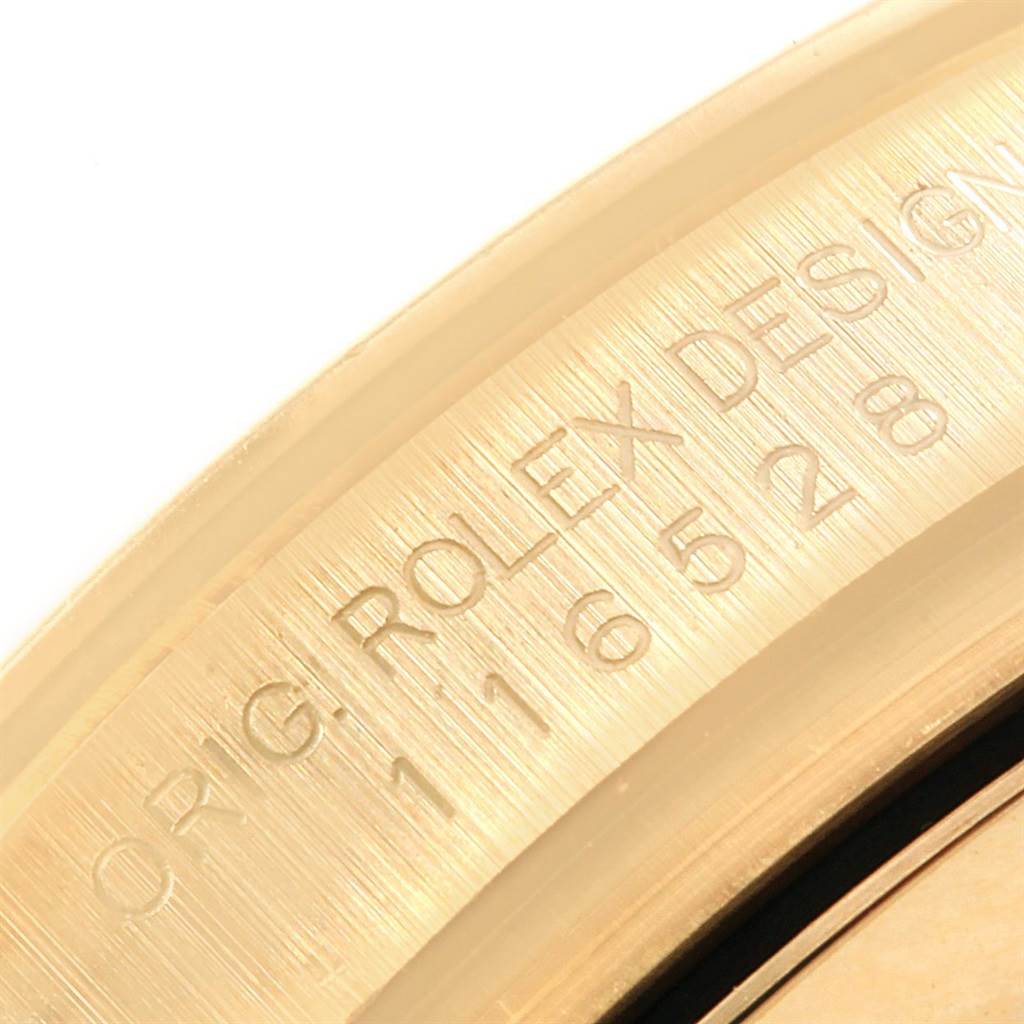 This close-up image shows the engraved serial number on the side of the bezel of a Rolex Daytona 116528 Men's Yellow Gold Champagne Dial 116528 Men's Yellow Gold Champagne Dial watch.